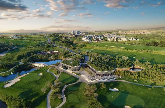 Aerial view of a golf clubhouse surrounded by fairways and greens